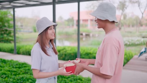 Man is sending a gift to his lover on a special anniversary in a sunny morning garden, enjoying a he