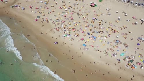 Mediterranean beach during summer with people in the water