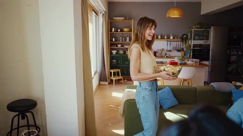 Woman brings pasta salad to family dinner