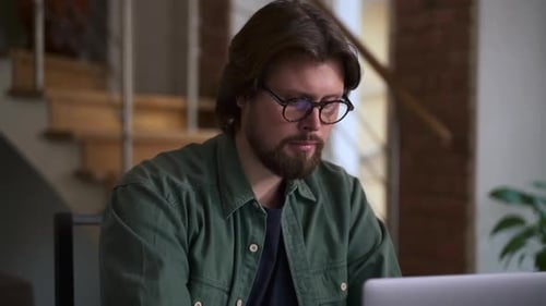 Man Working on Laptop Computer at Home