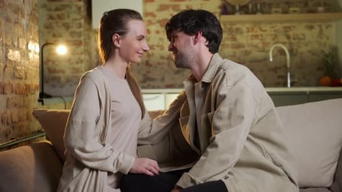 Happy Couple Laughing Together on a Couch