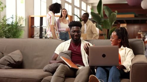 modern working room creative diverse young people divided into two groups with laptop, talking and d