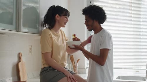 Affectionate Couple Sharing Food at Home