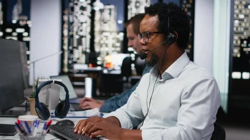 Startup Helpdesk System Administrator in Office Speaking in Headset Mic