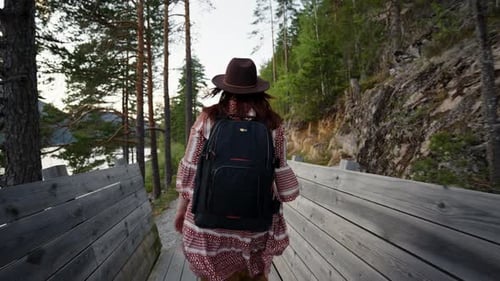 Girl Traveler Walks a Wooden Path Through the Forest Norway Telemark