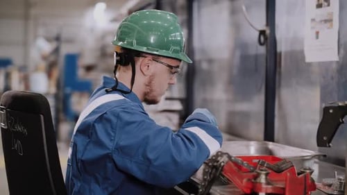Factory Worker Assembling Parts in Bright Industrial Setting