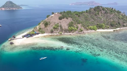 Aerial of small tropical Kelor Island. Island Hopping adventure explore Indonesia.