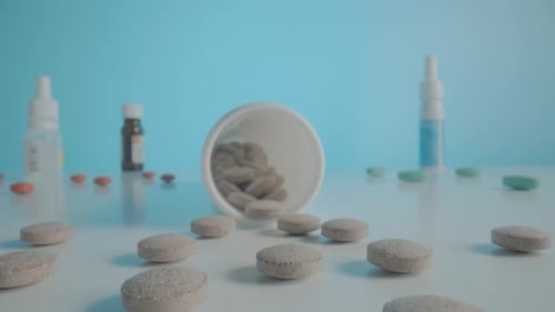Pills and Medicine Bottles on White Surface