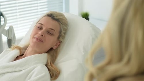 Blonde Woman Talking in a Medical Clinic