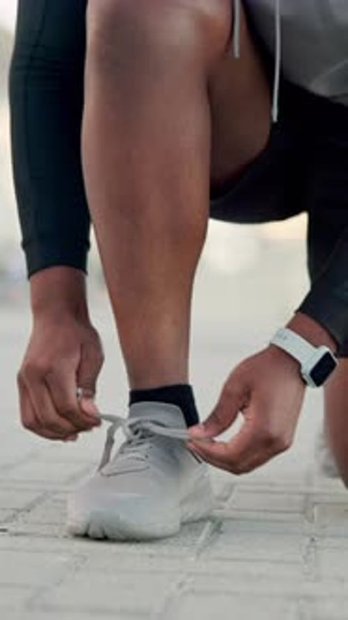 Hands, athlete and tie shoes outdoor to start running, morning cardio or exercise preparation