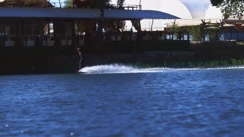 Sportsman Training Wake Boarding on Water Surface of Modern Wakeboarding Complex. Healthy