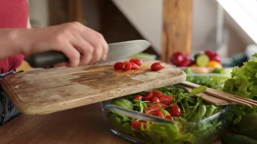 Preparing Fresh Salad With Tomatoes and Lettuce
