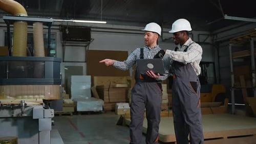 Two Engineers Discuss MDF Cutting on Laptop