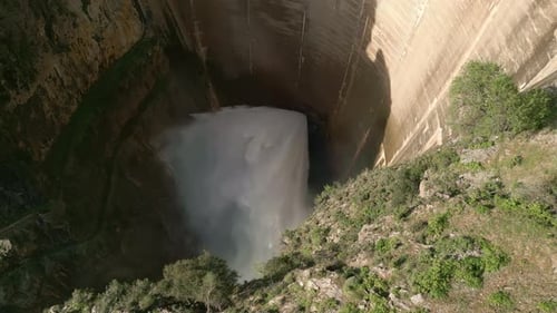 Dam discharge water. Aerial overhead view of water outlet from the dam.