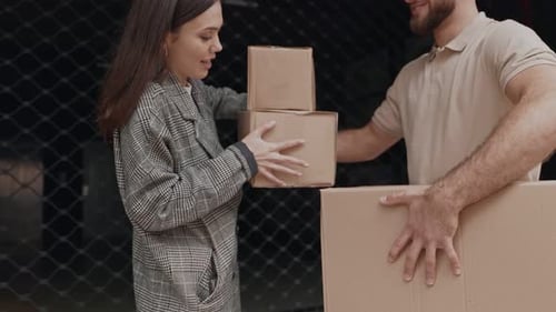 Woman Receiving Packages from Delivery Man