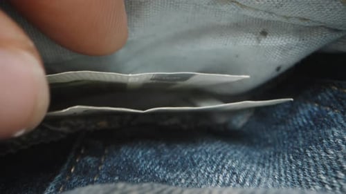 I take out a five-euro banknote from the pocket of my jeans. Dolly macro