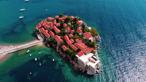 Aerial view of Sveti Stefan island and shore in a beautiful summer day, Montenegro from flying drone