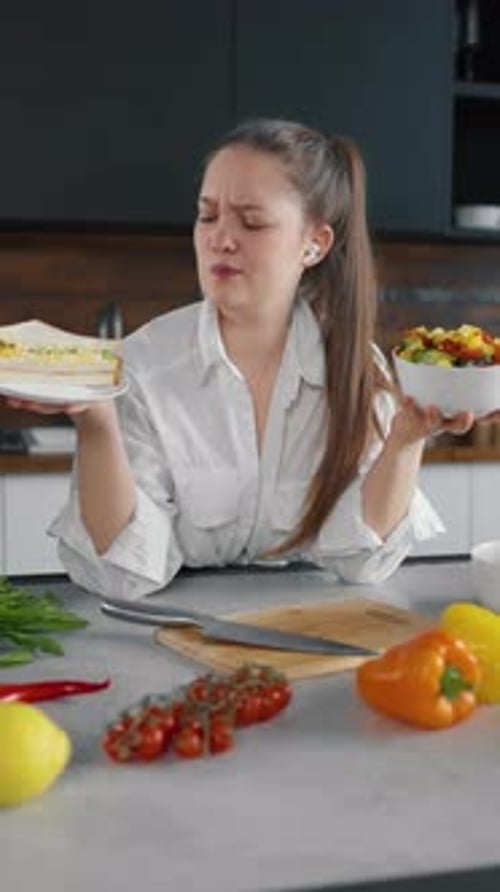 Woman Deciding Between Sandwich or Fruit Salad