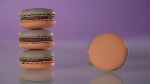 Colorful Macarons Stacked on Reflective Surface