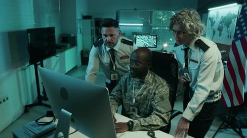 Male and Female Officers Discussing Reconnaissance at Army Headquarters