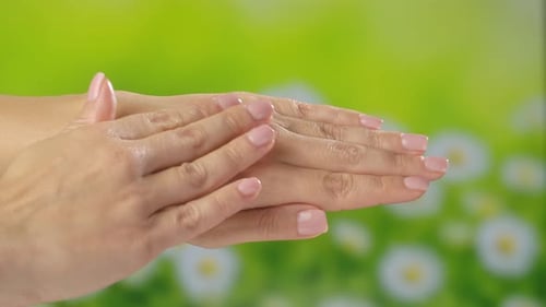 Woman Applying Moisturizing Cream to Hands