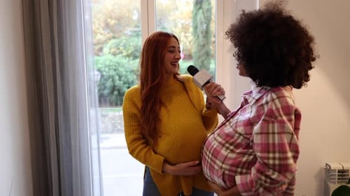 Two Pregnant Women Singing in a Home