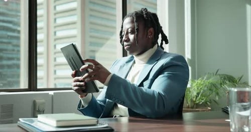 African businessman, tablet and reading in office for communication, news article