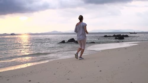 Woman Jogging During Beautiful Sunset on Beach, Super
