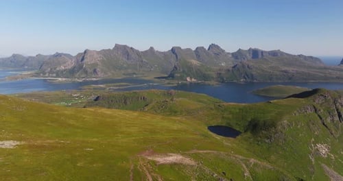 Scenic Aerial View Above Lush Green Yellow Mountains in Lofoten, Norway. Summer. Water