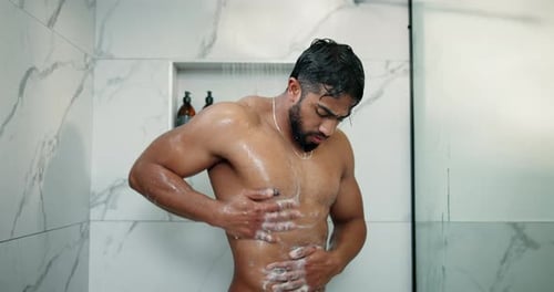 Muscular Man Washing Body with Soap in Shower