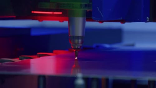 Laser engraving machine working on metal plate in factory