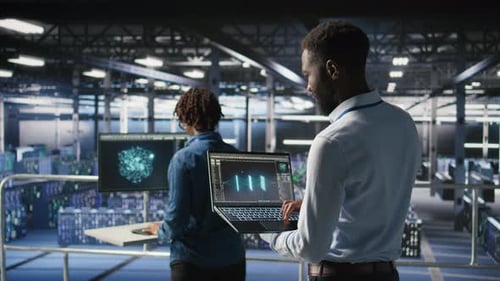 Engineers in Data Center Reviewing Large Language Model Visualizations on Laptop