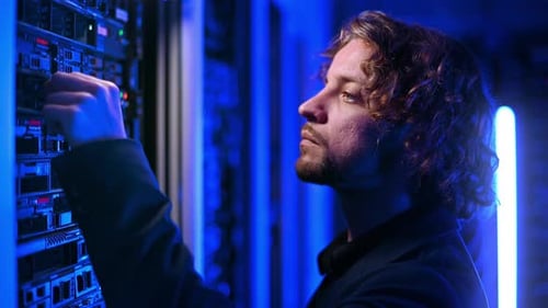 Man analysing servers in a data center