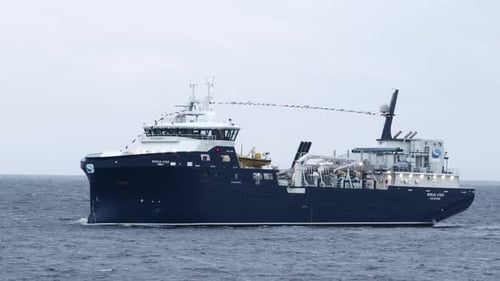 Shot of a single fish farming boat sailing into port. Shot near Stornoway on the Isle of Lewis, part