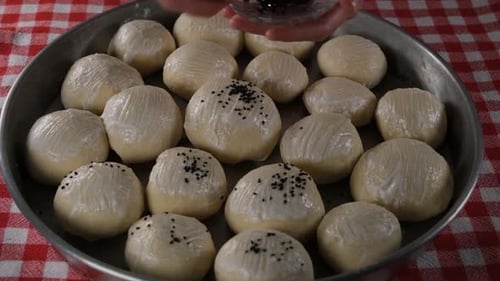 Seasoning Dough Balls with Sesame Seeds