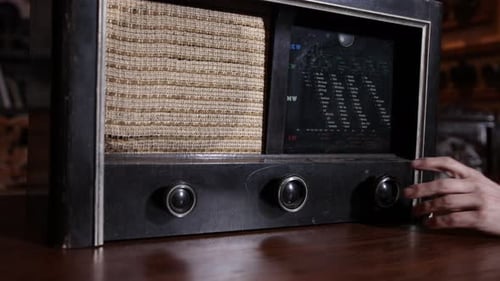 Hand Adjusting Dial on Antique Radio
