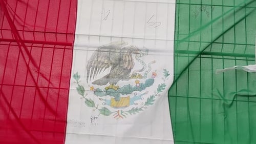 Close Up of a Mexican Flag on a Fence