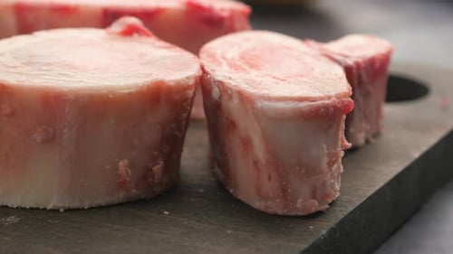 CloseUp of Fresh Bone Marrow Slices on Dark Surface