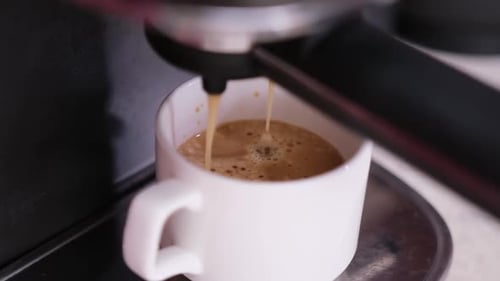 Coffee Pouring into Mug from Espresso Machine