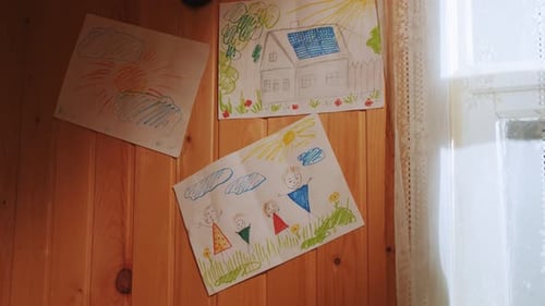 Funny Children Drawings Pinned on Wooden Wall in Room