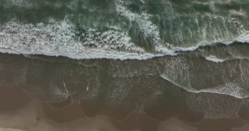 Waters of the Ocean Swirl on the Beach and Scenic Coastline