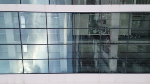 Aerial View of Moving Elevator Walls and Windows of Contemporary Business Center at Evening
