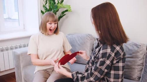 Woman Gives Homemade Card to Her Pleased Mother
