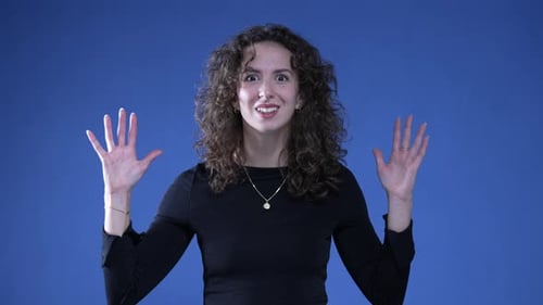 Surprised Woman with Hands Raised