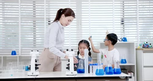 Teacher Demonstrating Science Experiment with Students