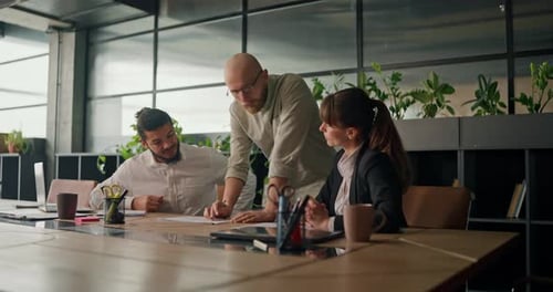 Team Collaborating on Documents in Modern Office