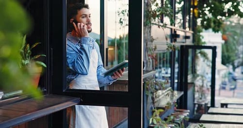 Smiling Man Talking on Phone in Coffee Shop