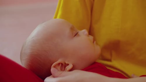 Infant Sleeping Peacefully in Gentle Arms