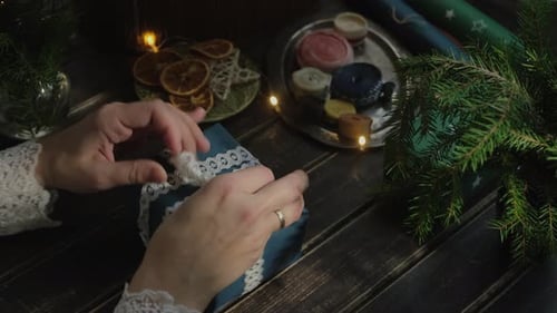 Hands Tie Lace Ribbon on Christmas Gift