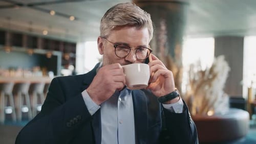 Man on Phone Drinking Coffee in Urban Setting